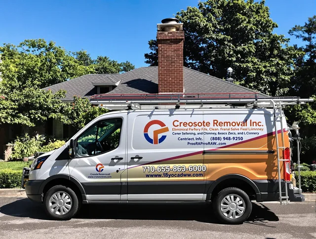 Clinton Chimney Sweep technician removing creosote safely in Clinton, MA
