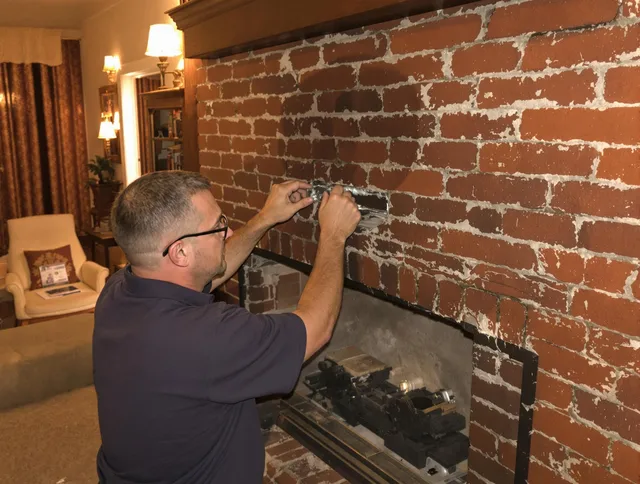 Clinton Chimney Sweep expert fixing a fireplace in Clinton, MA